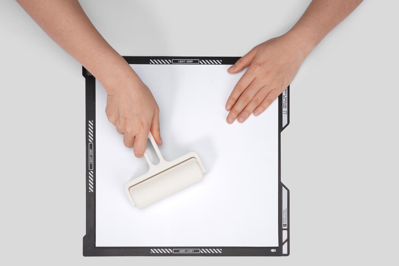 Use a roller tool to evenly flatten and compact the material;